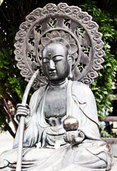 Bronze buddha with parasol in Japan